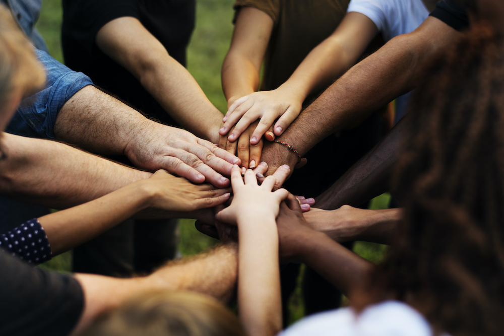 Group of people with their hands together